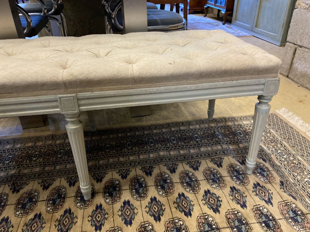 A Regency style cream painted dressing stool, with a buttoned seat, width 122cm, depth 45cm, height 44cm